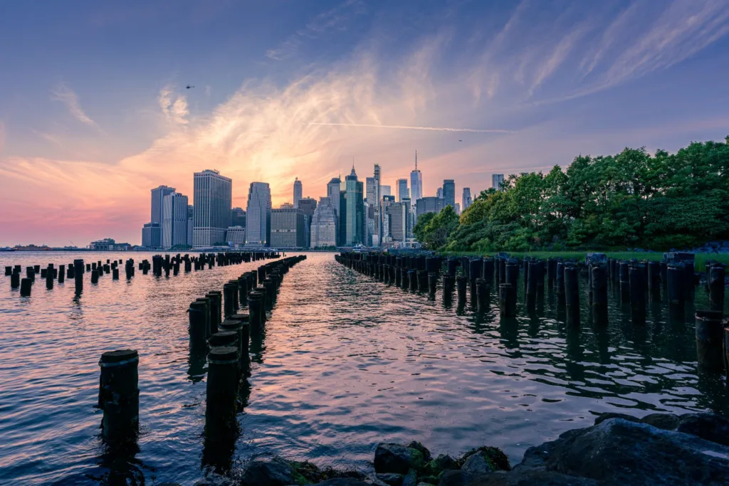 Manhattan skyline at sunset seen across the East River from Brooklyn Bridge Park